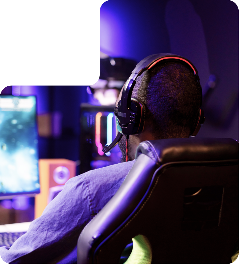 Gamer using professional headphones at a high-performance setup Gamer using professional headphones at a high-performance setup