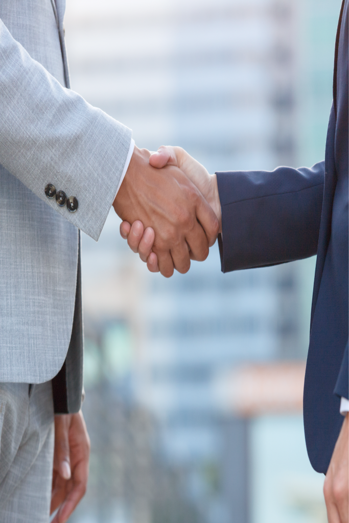 Business partners shaking hands after an acquisition agreement Business partners shaking hands after an acquisition agreement